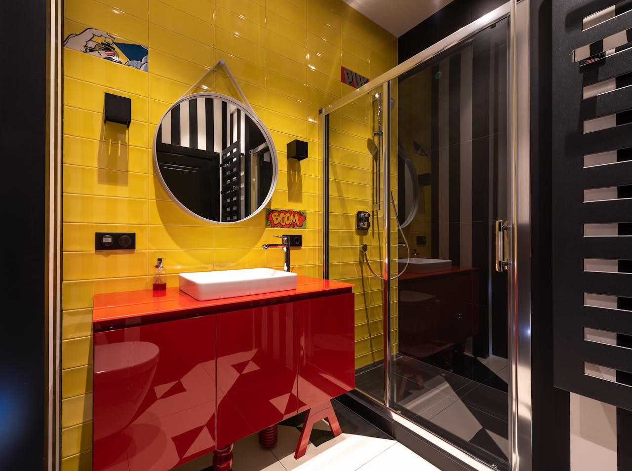 about-us A colorful and stylish bathroom with striking yellow tiles and modern fixtures.