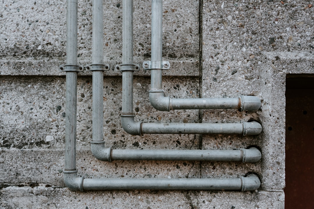 services-01 white-metal-pipe-on-gray-concrete-wall-bu4lhkihr-e